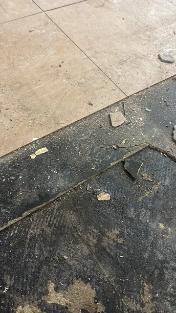 Black bitumen mastic floor removal in a SW1 flat